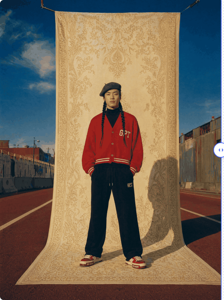 ClearCut's before/after slider — dragging the divider across a full-body photo reveals the busy street-and-tapestry background being cleanly removed, leaving the subject cut out on transparency with braids and edges intact